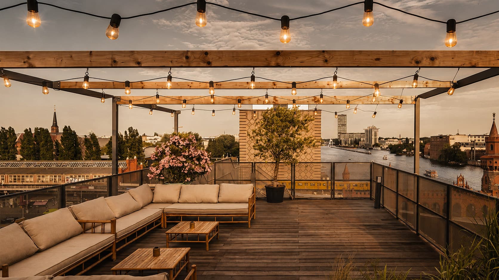 Sunny rooftop terrace with lounge furniture and a view of the Spree