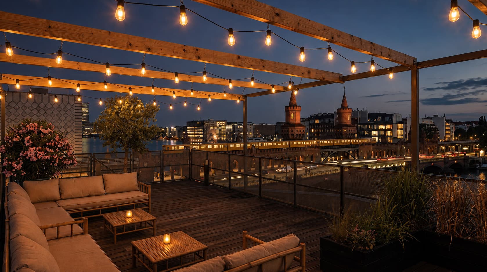 Rooftop terrace at blue hour with fairy lights and a view of the Oberbaumbrücke