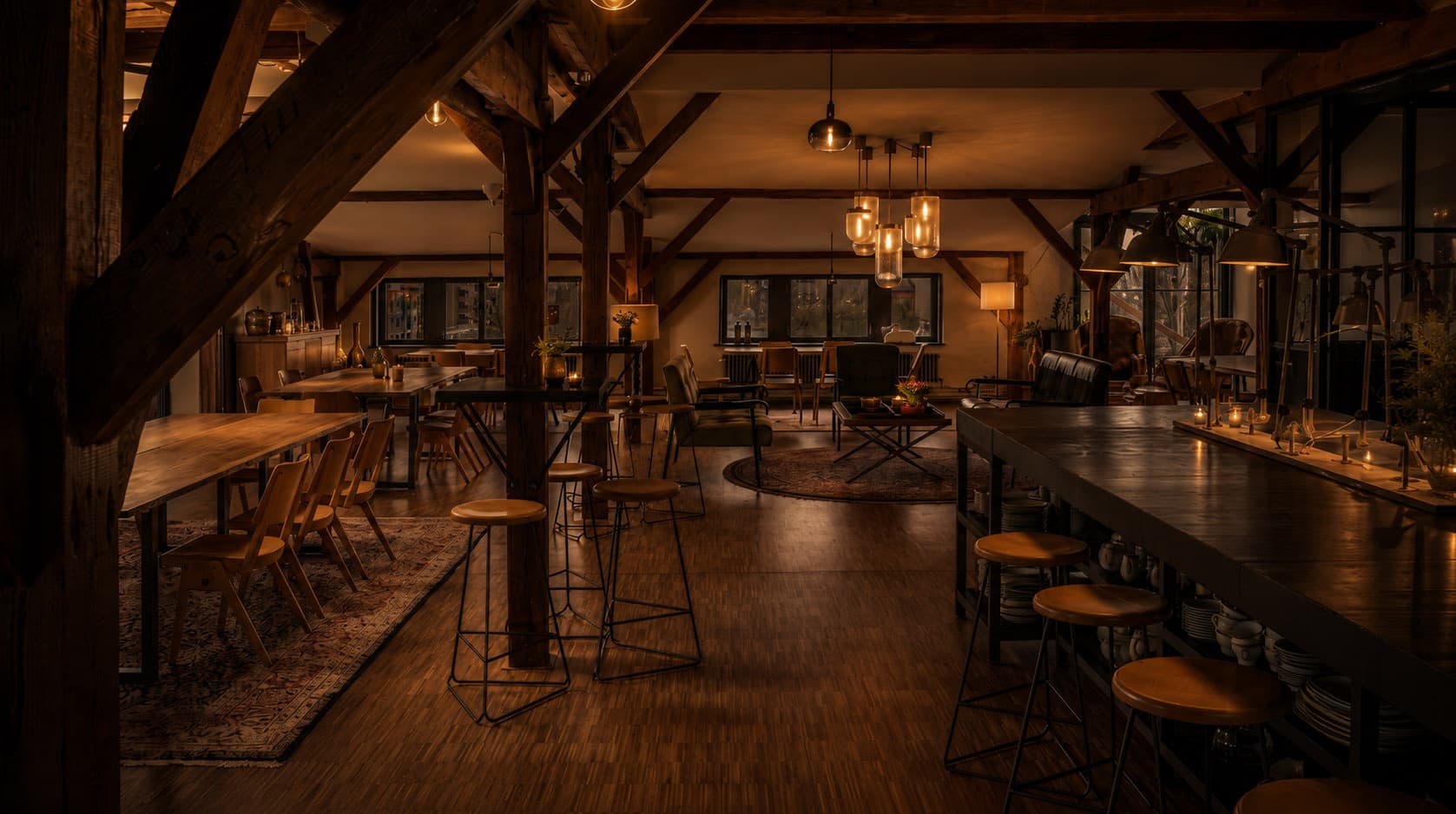 Industrial loft with wooden beams, bar and bistro tables
